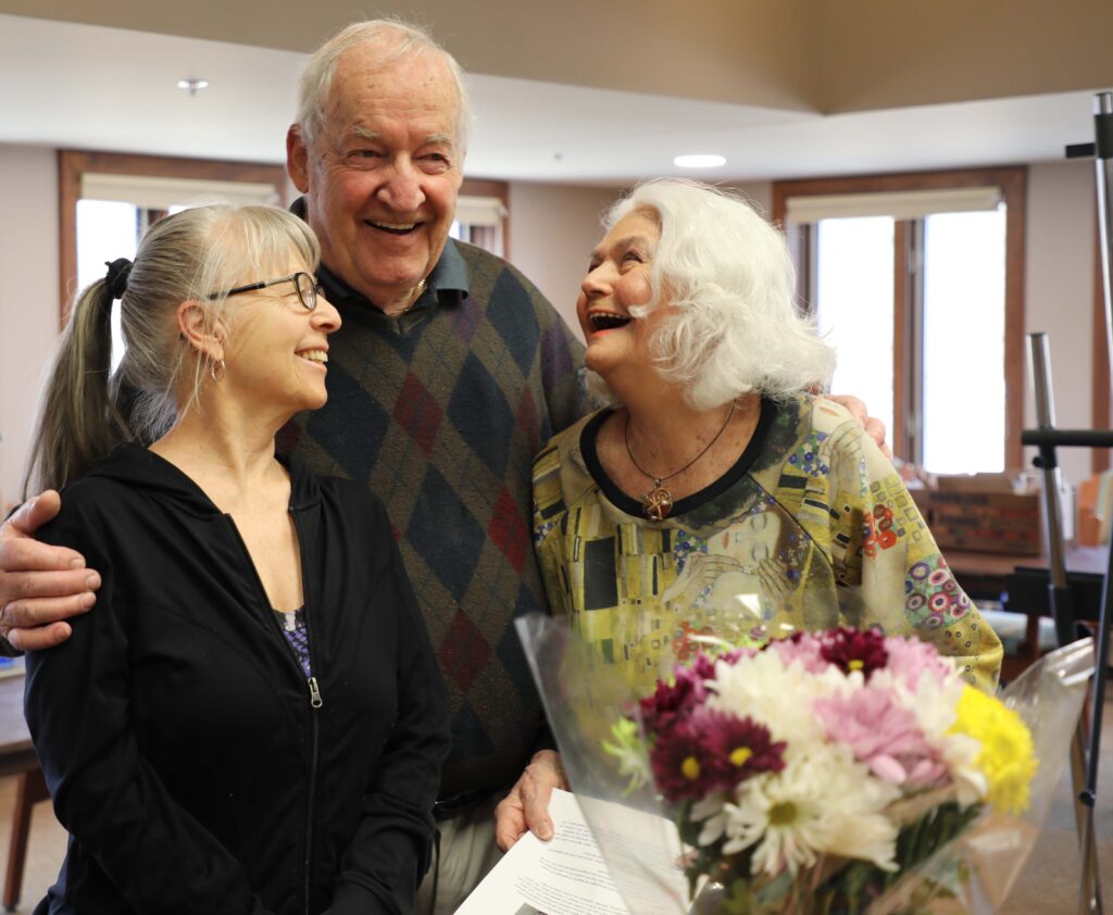 Residents at Three Pillars smiling in art class