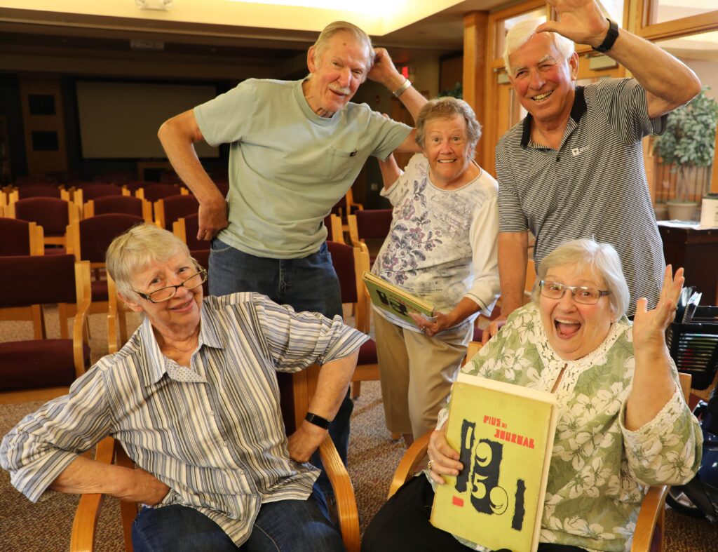 Three Pillars residents acting silly as students and teacher from the same high school.