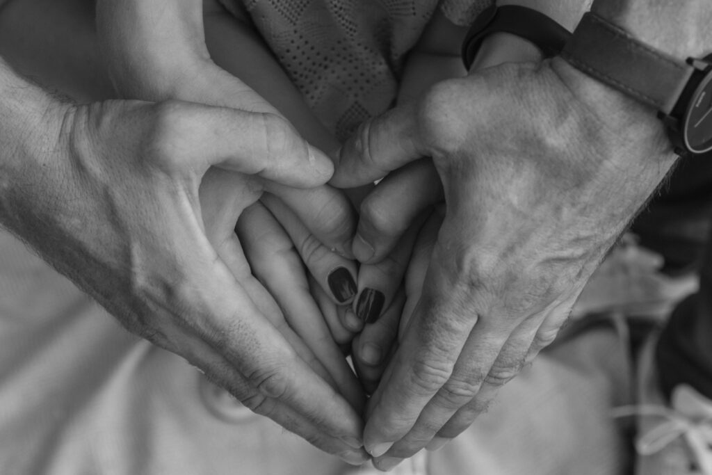 Hands on top of one another making the shape of a heart