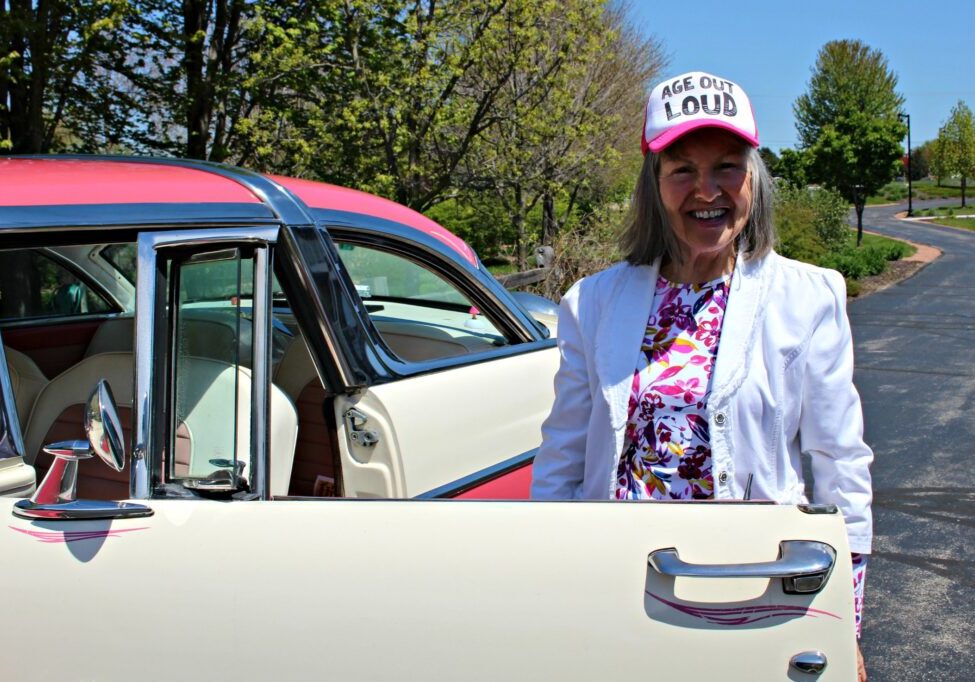 Elderly woman with vintage car