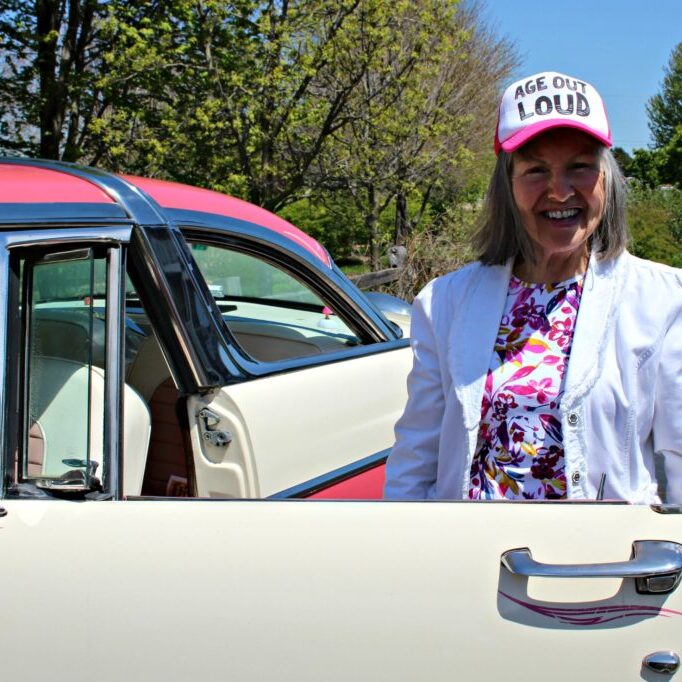 Elderly woman with vintage car