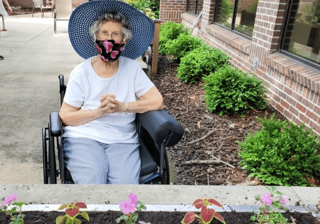 Elderly woman planting flowers