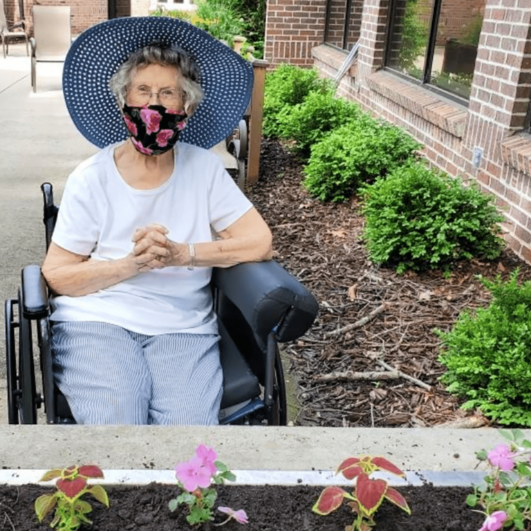Elderly woman planting flowers
