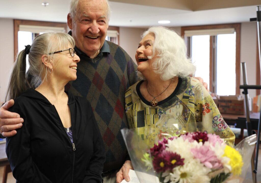 Residents at Three Pillars smiling in art class