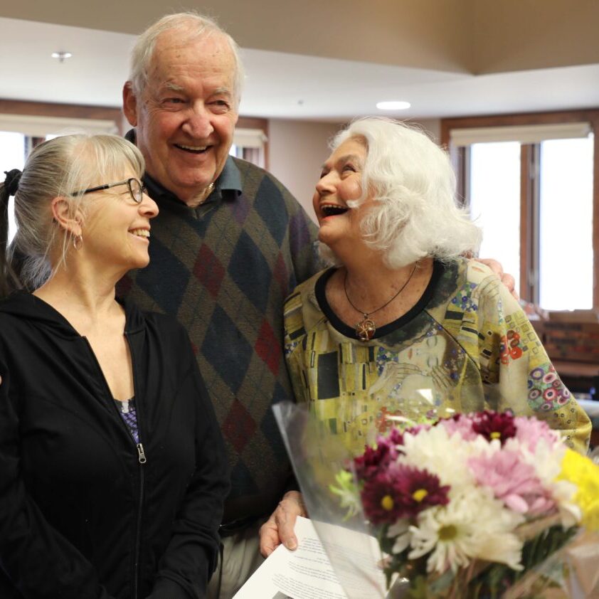 Residents at Three Pillars smiling in art class