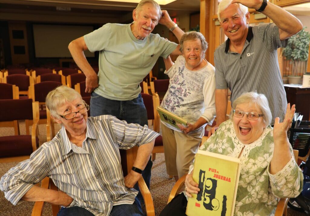 Three Pillars residents acting silly as students and teacher from the same high school.