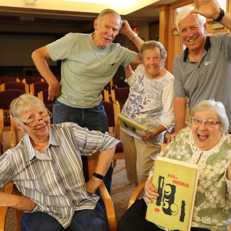 Three Pillars residents acting silly as students and teacher from the same high school.